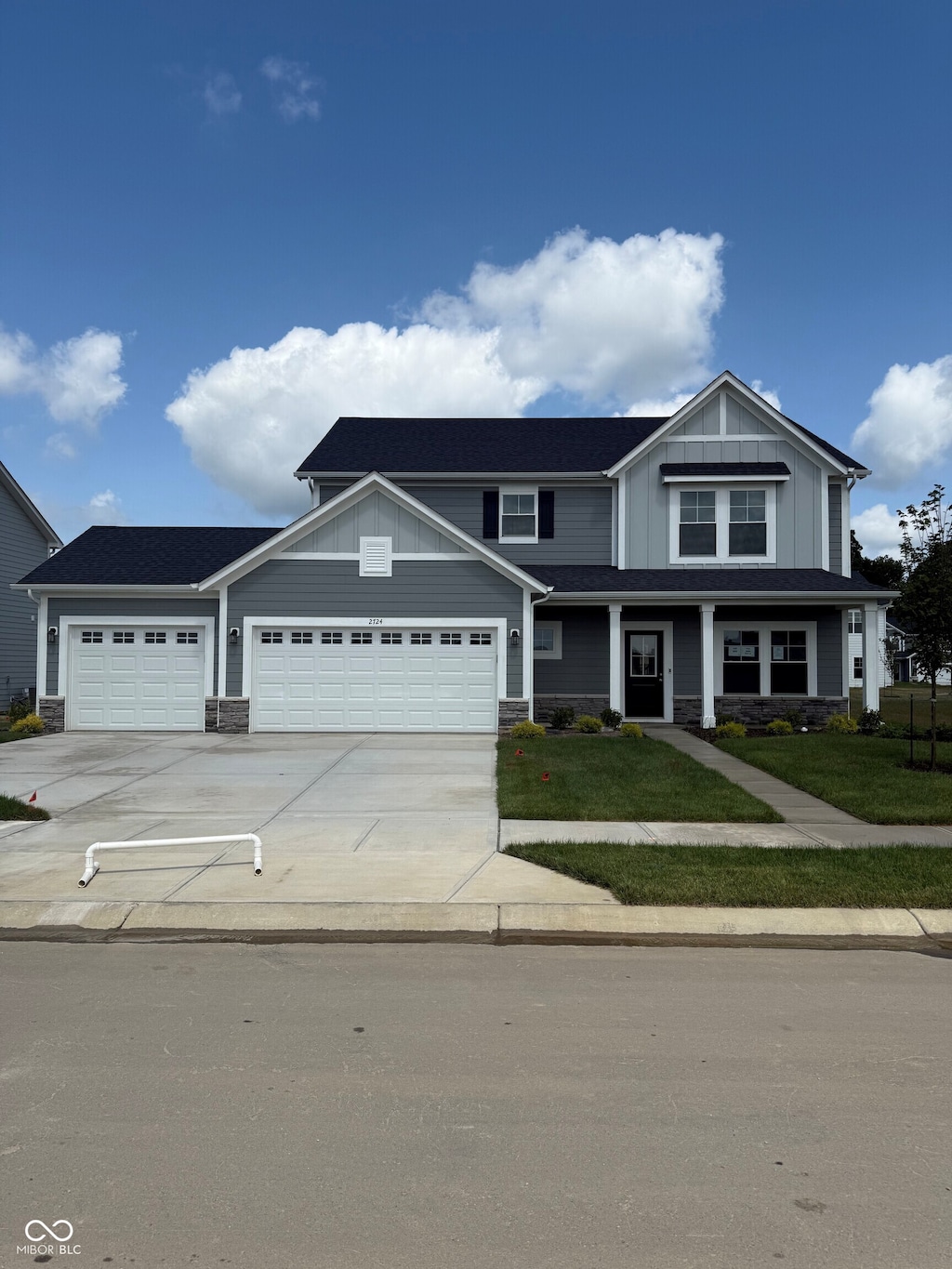 2724 Glade Ave, Plainfield, IN 46168 - view of front of property featuring stone siding, concrete driveway, a garage, and board and batten siding