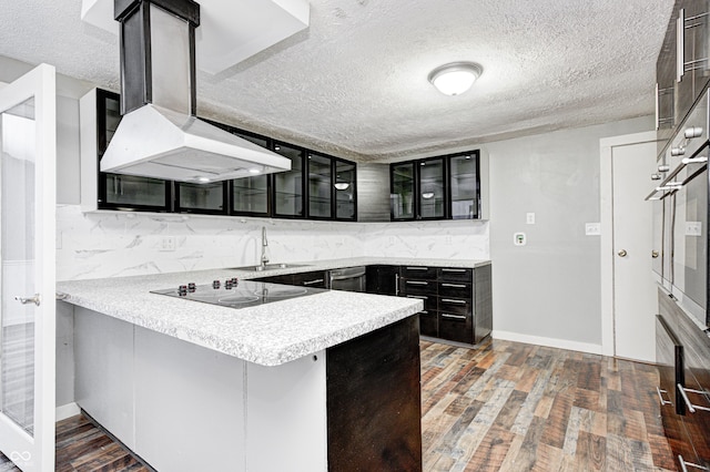kitchen with stainless steel oven, wood finished floors, black electric stovetop, glass insert cabinets, and a textured ceiling