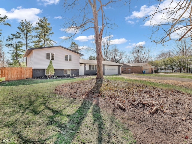 view of front of house with fence, an attached garage, a front lawn, and driveway