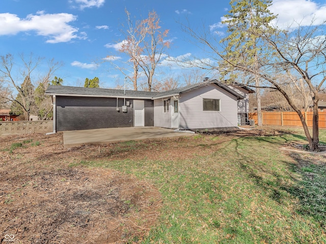 back of house with a lawn, fence, and a patio area