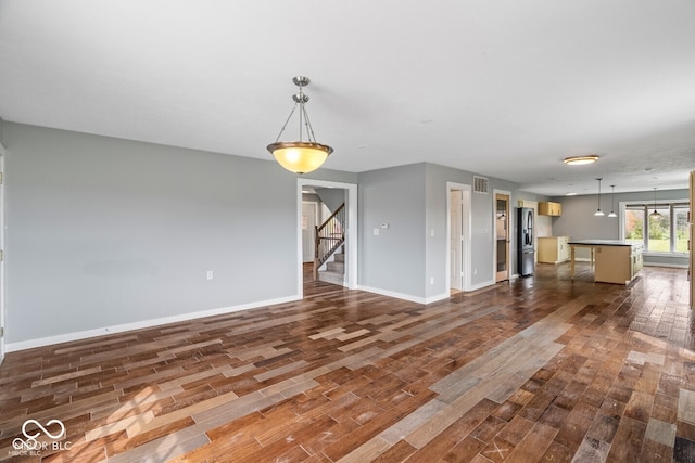6519 Rothchild Blvd, Indianapolis, IN 46278 - unfurnished living room featuring baseboards, stairway, and dark wood-style flooring