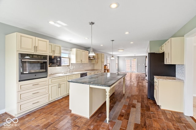 6519 Rothchild Blvd, Indianapolis, IN 46278 - kitchen with a sink, cream cabinetry, black appliances, and a kitchen island
