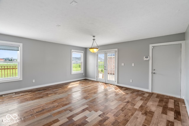 6519 Rothchild Blvd, Indianapolis, IN 46278 - unfurnished dining area with baseboards, french doors, wood finished floors, and visible vents