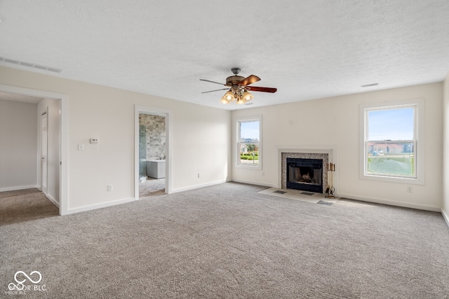6519 Rothchild Blvd, Indianapolis, IN 46278 - unfurnished living room featuring a tiled fireplace, carpet flooring, baseboards, and a ceiling fan