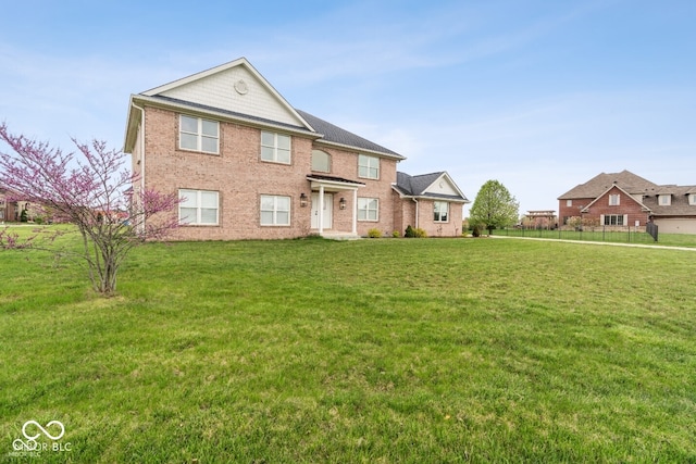 6519 Rothchild Blvd, Indianapolis, IN 46278 - view of front facade with brick siding, fence, and a front yard