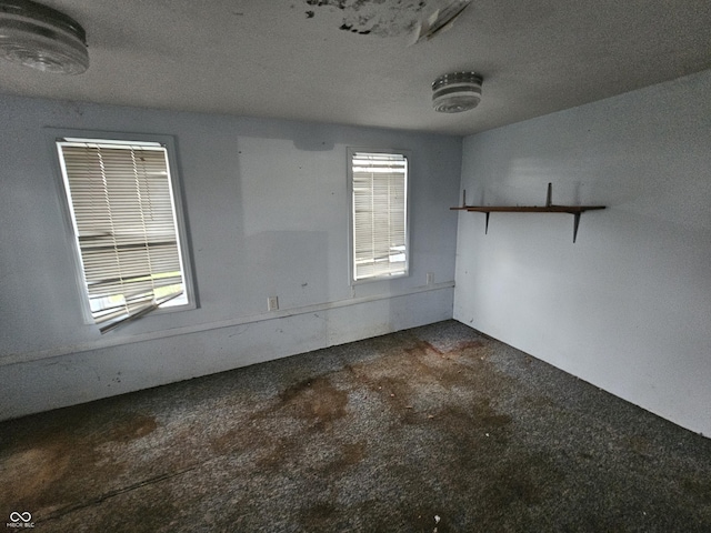 unfurnished room with unfinished concrete floors