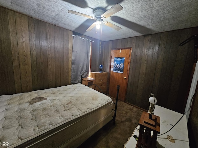 bedroom with wooden walls, carpet, and ceiling fan