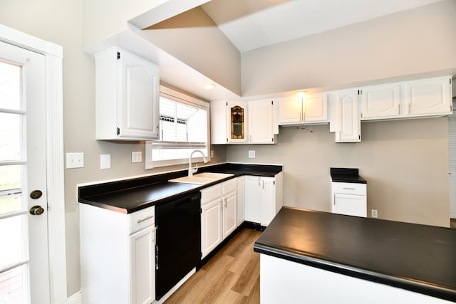 106 S Wayburn St, Indianapolis, IN 46229 - kitchen with dark countertops, a sink, light wood-style floors, white cabinets, and black dishwasher