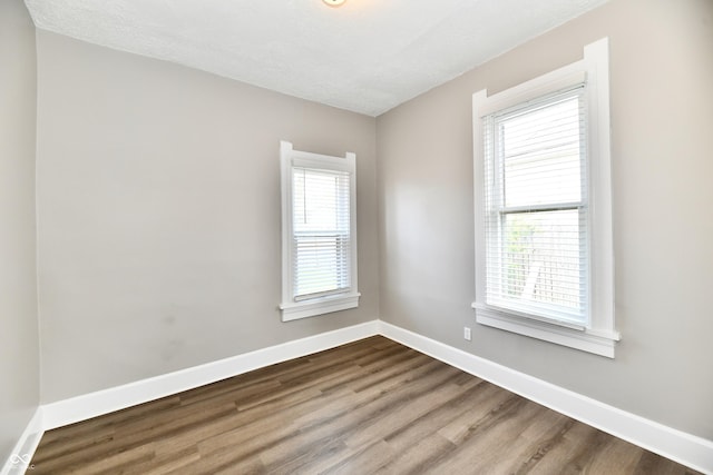 106 S Wayburn St, Indianapolis, IN 46229 - spare room with baseboards and dark wood-style floors