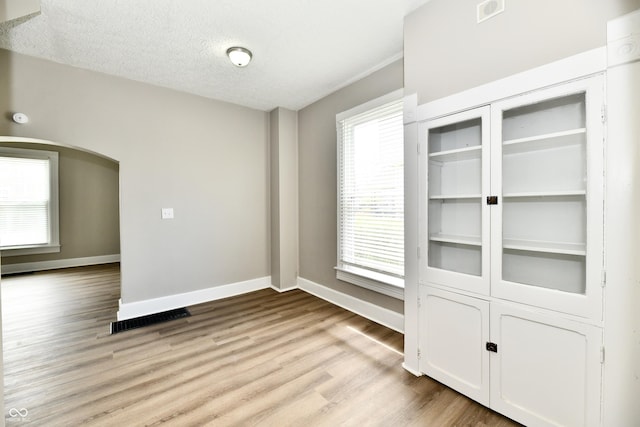 106 S Wayburn St, Indianapolis, IN 46229 - interior space with arched walkways, baseboards, visible vents, and light wood-style flooring