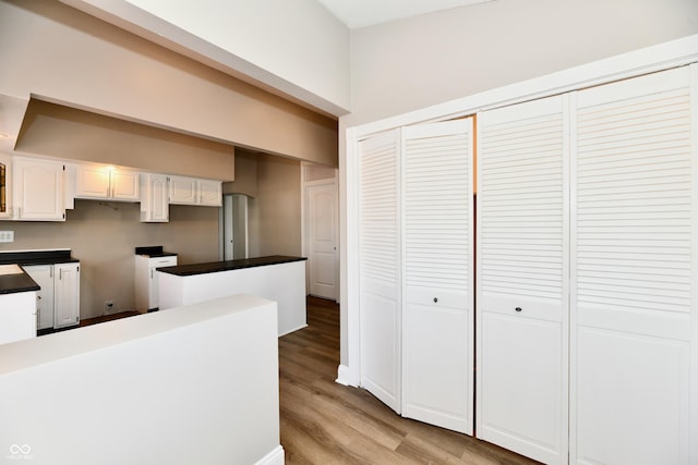 106 S Wayburn St, Indianapolis, IN 46229 - kitchen with dark countertops, white cabinetry, and light wood-style floors