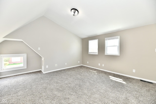 106 S Wayburn St, Indianapolis, IN 46229 - unfurnished living room with plenty of natural light, vaulted ceiling, visible vents, and carpet