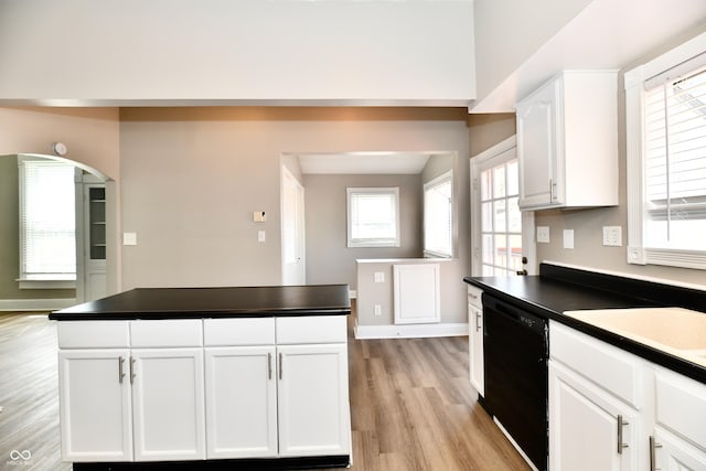 106 S Wayburn St, Indianapolis, IN 46229 - kitchen with dark countertops, dishwasher, baseboards, and light wood-style floors