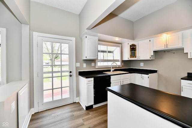 106 S Wayburn St, Indianapolis, IN 46229 - kitchen with dark countertops, dishwasher, a sink, and white cabinetry