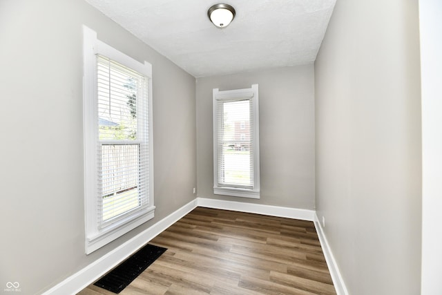 106 S Wayburn St, Indianapolis, IN 46229 - empty room featuring wood finished floors, visible vents, and baseboards