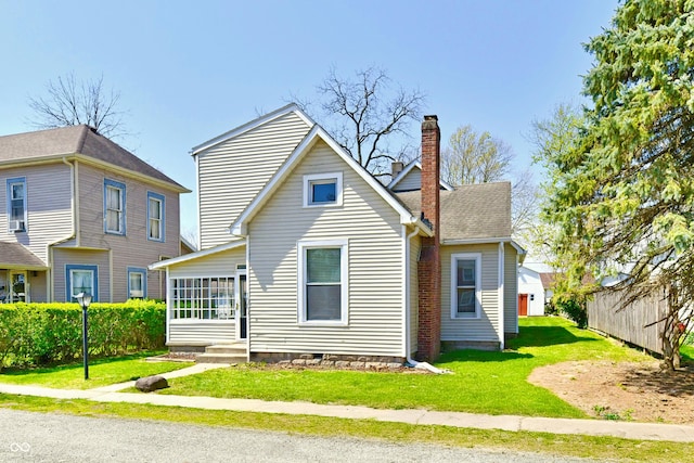 106 S Wayburn St, Indianapolis, IN 46229 - back of house with a chimney, fence, a yard, and entry steps