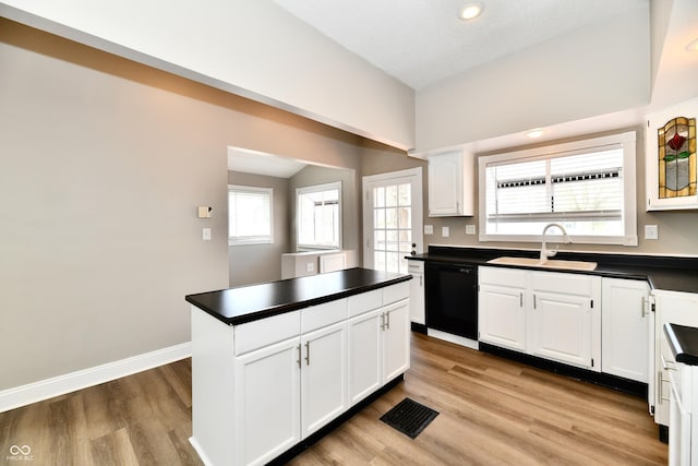 106 S Wayburn St, Indianapolis, IN 46229 - kitchen featuring white cabinets, dark countertops, black dishwasher, and a sink