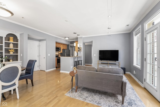 living room with crown molding, light wood-style floors, baseboards, and visible vents