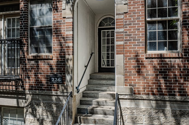 property entrance with brick siding