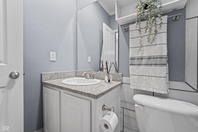 half bathroom with vanity and toilet