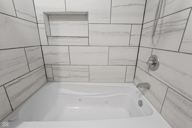 bathroom with a combined bath / shower with jetted tub