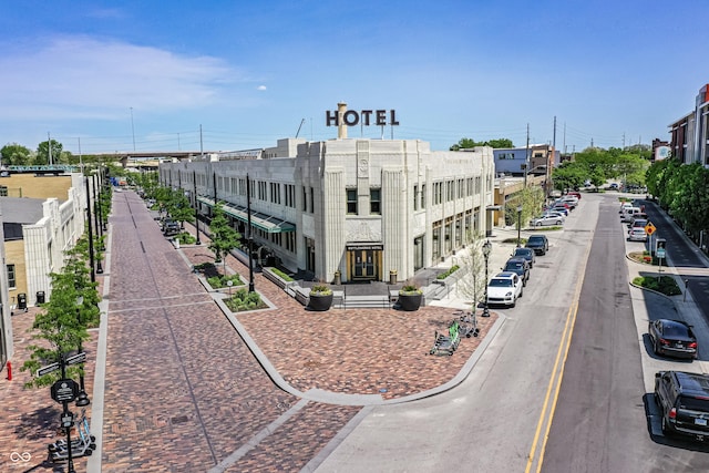 exterior space featuring curbs, street lights, and sidewalks