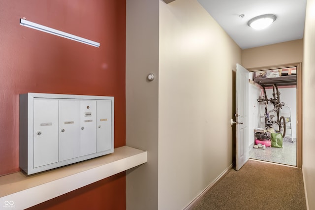 hall with carpet and mail area