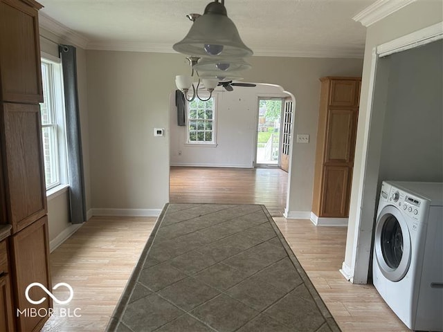 1640 Lawton Ave, Columbus, IN 47201 - laundry area featuring washer / dryer, light wood-style floors, plenty of natural light, crown molding, and arched walkways