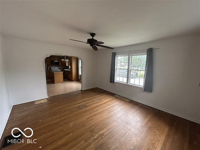 1640 Lawton Ave, Columbus, IN 47201 - unfurnished room with ceiling fan, dark wood-style flooring, and arched walkways