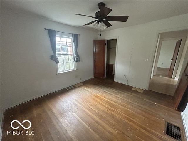 1640 Lawton Ave, Columbus, IN 47201 - unfurnished bedroom with hardwood / wood-style floors, a closet, and a ceiling fan