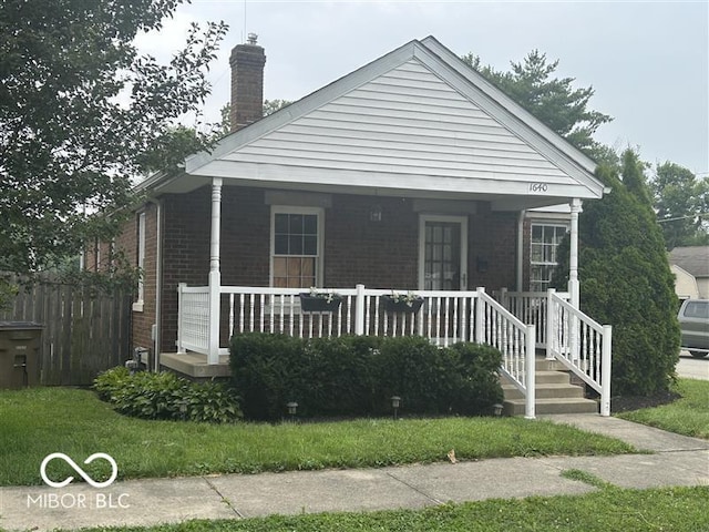 1640 Lawton Ave, Columbus, IN 47201 - view of front of property featuring covered porch, brick siding, and a chimney
