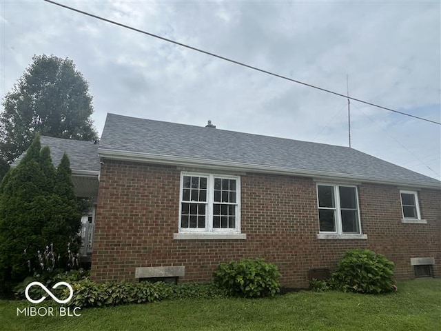 1640 Lawton Ave, Columbus, IN 47201 - view of home's exterior featuring brick siding, a shingled roof, and a yard