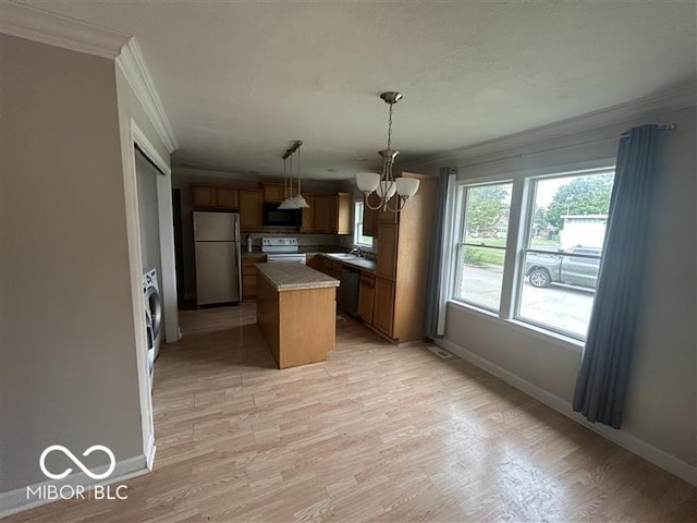 1640 Lawton Ave, Columbus, IN 47201 - kitchen with freestanding refrigerator, black microwave, white electric range oven, crown molding, and a chandelier