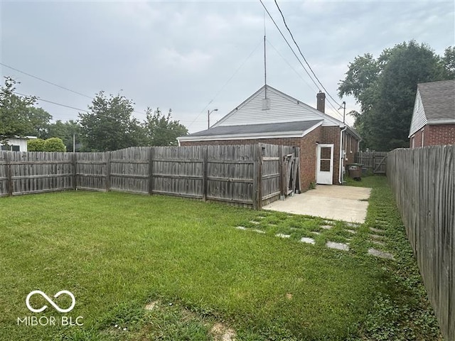 1640 Lawton Ave, Columbus, IN 47201 - fenced backyard with a patio area