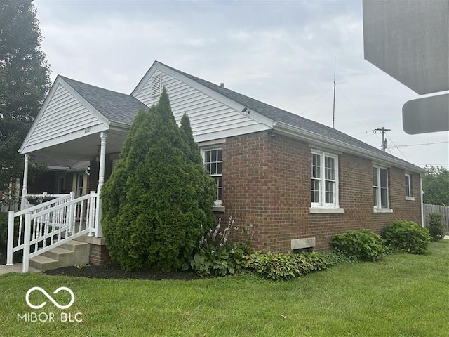 1640 Lawton Ave, Columbus, IN 47201 - view of home's exterior featuring brick siding, a lawn, and roof with shingles