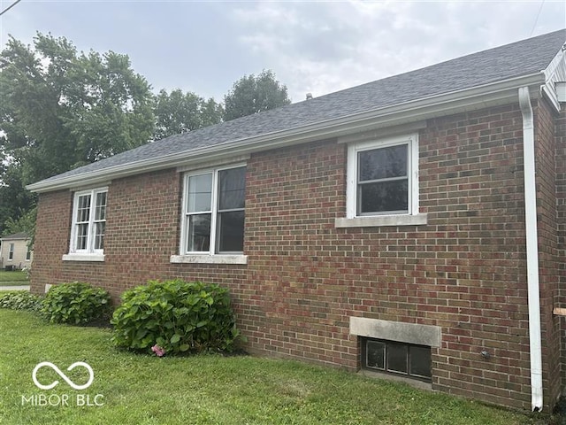 1640 Lawton Ave, Columbus, IN 47201 - view of side of property featuring a yard, brick siding, and a shingled roof