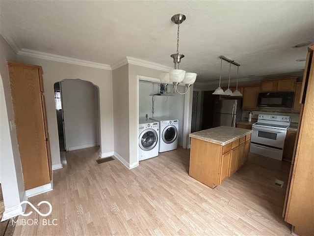 1640 Lawton Ave, Columbus, IN 47201 - kitchen with electric stove, black microwave, washer and dryer, freestanding refrigerator, and a center island