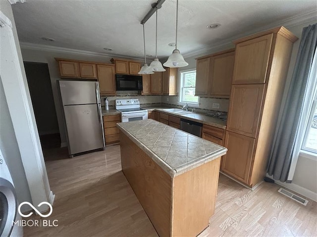 1640 Lawton Ave, Columbus, IN 47201 - kitchen with appliances with stainless steel finishes, ornamental molding, light wood-style flooring, a center island, and pendant lighting