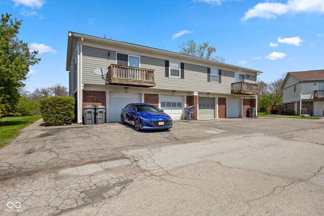 4464 Four Seasons Cir, Indianapolis, IN 46226 - multi unit property featuring brick siding, an attached garage, a balcony, and driveway