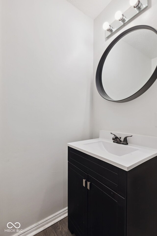 4464 Four Seasons Cir, Indianapolis, IN 46226 - bathroom with baseboards, wood finished floors, and vanity