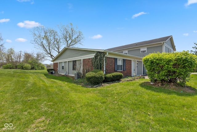 4464 Four Seasons Cir, Indianapolis, IN 46226 - exterior space featuring brick siding, a lawn, and central AC
