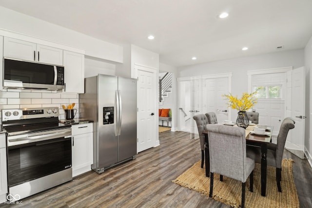 625 N Temple Ave, Indianapolis, IN 46201 - kitchen with appliances with stainless steel finishes, dark wood-type flooring, decorative backsplash, recessed lighting, and white cabinetry