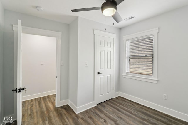 625 N Temple Ave, Indianapolis, IN 46201 - unfurnished bedroom featuring dark wood finished floors, baseboards, a closet, and a ceiling fan