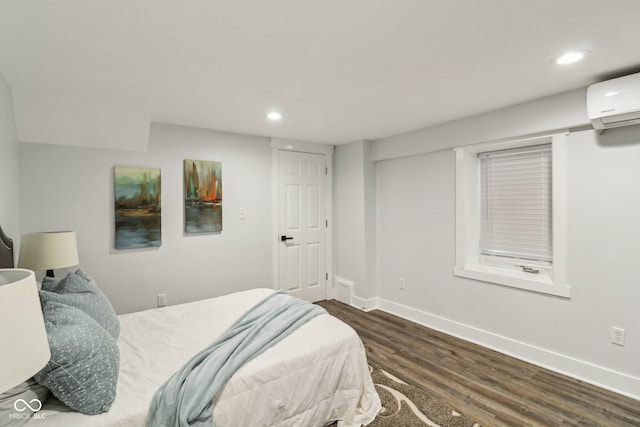 625 N Temple Ave, Indianapolis, IN 46201 - bedroom with recessed lighting, a wall mounted AC, wood finished floors, and baseboards
