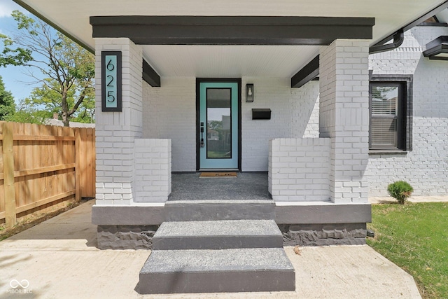 625 N Temple Ave, Indianapolis, IN 46201 - entrance to property with covered porch, fence, and brick siding