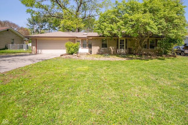 4710 E 56th St, Indianapolis, IN 46220 - ranch-style house with a garage, fence, driveway, and a front yard