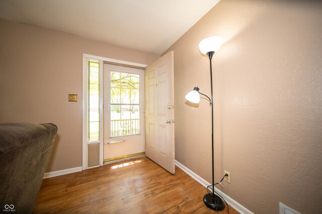 4710 E 56th St, Indianapolis, IN 46220 - doorway with wood finished floors, visible vents, and baseboards