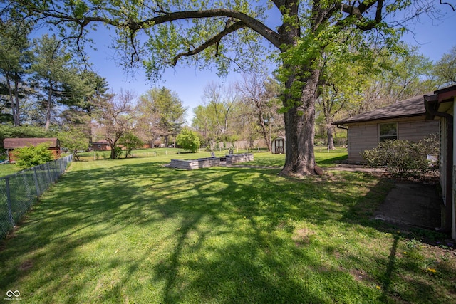 4710 E 56th St, Indianapolis, IN 46220 - view of yard featuring a fenced backyard, a shed, and an outbuilding
