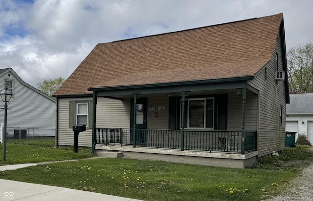 518 N Grant St, Lebanon, IN 46052 - view of front of home featuring a porch, a shingled roof, a garage, and central air condition unit