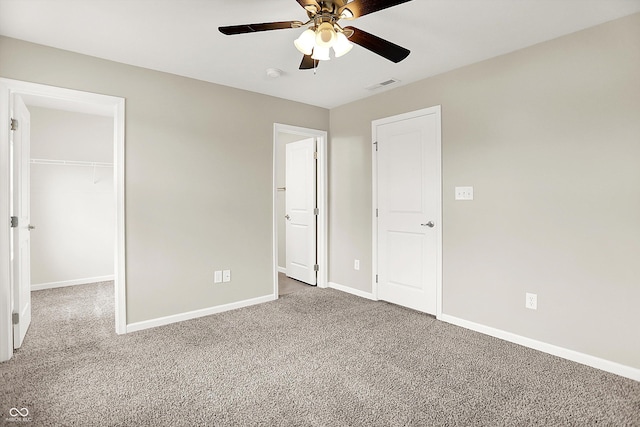 13567 Moorcroft Dr, Fishers, IN 46037 - unfurnished bedroom with carpet, a spacious closet, baseboards, a closet, and a ceiling fan